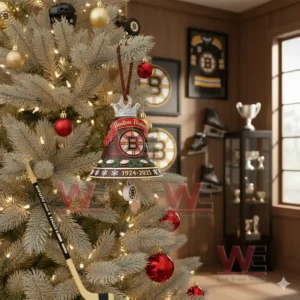 A Boston Bruins anniversary bell ornament with brown and gold details hanging on a decorated Christmas tree!