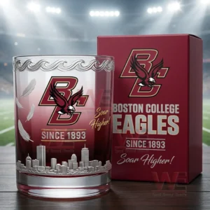 A close up view of a Boston College Eagles glass with red coloring feather graphics and a skyline design displayed beside its matching red box!