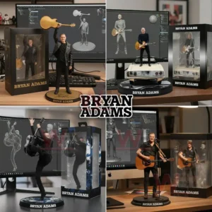 Several Bryan Adams collectible figures posed with guitars on a desk in front of computer screens showing digital models!