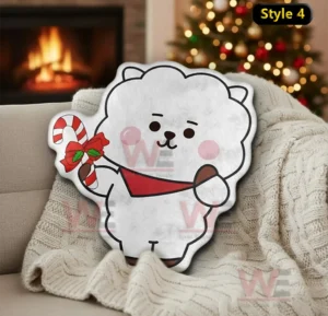 White bear christmas pillow holding a candy cane on a sofa near a fireplace and holiday tree!