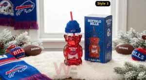 Buffalo Bills 66th Anniversary 1966-2026 Bear Glass Cup 5 Buffalo Bills themed bear glass cup displayed with winter decorations football items and a branded box!
