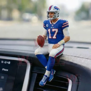 A miniature football player in Buffalo Bills uniform sitting on a car dashboard holding a football!