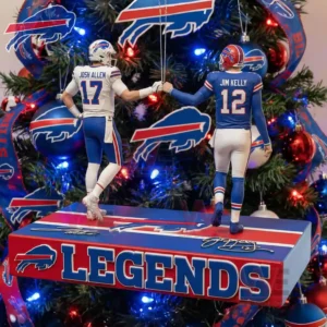 Two Buffalo Bills player figures including one in a white uniform and one in a blue uniform stand facing each other on a platform and bump fists with a Bills themed Christmas tree in the background!