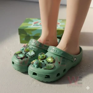 Bulbasaur Pokemon Crocs Clogs with Charms 4 Green Bulbasaur themed clogs with assorted charms worn by a person with the box visible in the background!