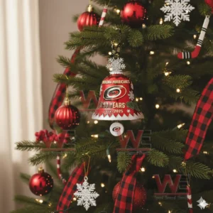 A red Carolina Hurricanes anniversary bell ornament with snowflakes and holly hanging on a decorated Christmas tree!