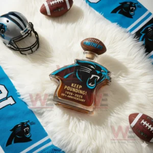 A Panthers logo bottle is positioned on a fluffy white surface with football gear and team colors placed nearby!
