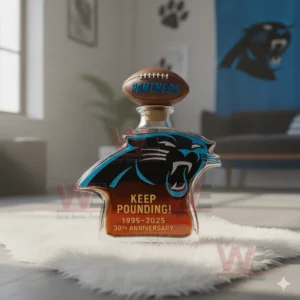 A Panthers logo bottle with bold blue and black colors placed on a fluffy surface in a sports themed room!