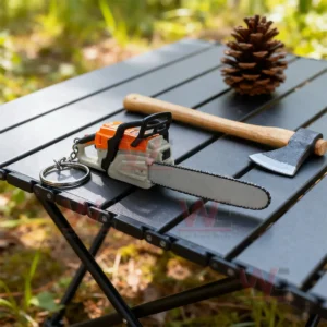 Chainsaw Keychain Portable Chainsaw Key Ring 6 Mini chainsaw keychain on an outdoor table beside an axe and pinecone!