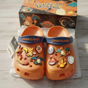 Charizard Pokemon Crocs Clogs with Charms 5 Orange Charizard themed clogs arranged in front of a matching Pokémon box decorated with fire and character charms!