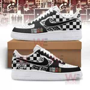 Black and white checkerboard graphic sneakers shown with side views on a brown shoebox against a band poster collage background.