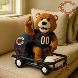 Plush bear in a sports jersey sitting in a toy cart with a Bears football!