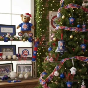 A blue Chicago Cubs anniversary bell ornament with snowflakes and gold accents hanging on a decorated Christmas tree!