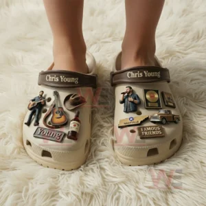 Feet wearing beige clogs decorated with Chris Young inspired music charms on a fluffy indoor surface!