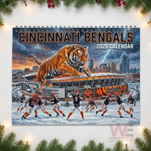 Giant tiger over stadium with players practicing on snowy field for Bengals 2026 calendar.