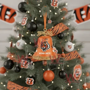 An orange Cincinnati Bengals holiday bell ornament with paw prints snowflakes and team branding hanging on a decorated Christmas tree!