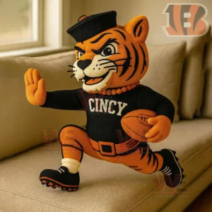 Plush tiger mascot in black clothing holding a football and posing as if running!
