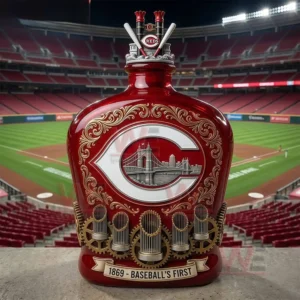 Cincinnati Reds themed red commemorative bottle positioned at a baseball stadium with field and seating visible in the background!