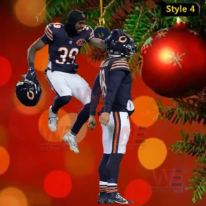 Two football player ornament hanging by a string on a red holiday background with Christmas ornaments and greenery!