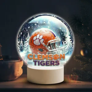 Snowy themed decorative globe featuring a Clemson Tigers helmet glowing on a white base!
