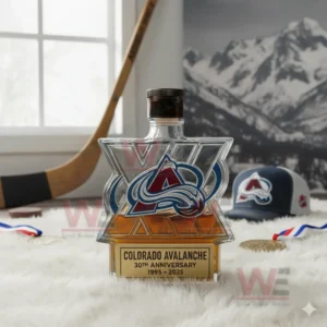 Colorado Avalanche 30th Anniversary 1995-2025 Whiskey Bottle 4 A Colorado Avalanche logo bottle with a brown cap resting on a white rug in a room decorated with hockey equipment and a mountain photo!