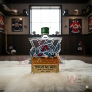 Colorado Avalanche 30th Anniversary 1995-2025 Whiskey Bottle 5 A Colorado Avalanche logo shaped bottle with a green cap displayed on a white rug inside a hockey themed collection room!