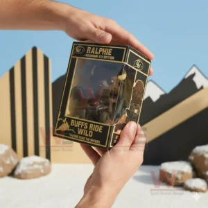 Hands holding a boxed buffalo mascot figure riding a mountain vehicle in an outdoor scene!
