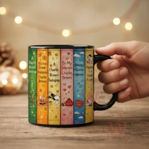 Cool Snoopy Coffee Mug 3 Black ceramic coffee mug with Snoopy themed illustrated book spines representing holiday stories arranged like a bookshelf!