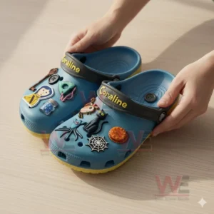 A pair of blue themed clogs shown on a table featuring multiple decorative charms inspired by a fantasy adventure story!