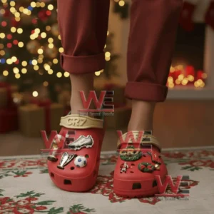 CR7 red clogs with football and Christmas charms worn by a person standing in a holiday decorated room!