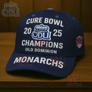 Navy Old Dominion Monarchs cap with Cure Bowl 2025 Champions embroidery and ODU logo displayed on a wooden surface.