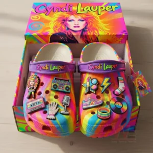 Colorful music inspired clogs presented in a decorated box with bright patterns and playful decorative charms.