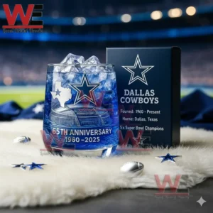 Dallas Cowboys 65th Anniversary 196-2025 Whiskey Glass 5 A blue Dallas Cowboys anniversary glass with ice beside a team box on a white mat with a stadium backdrop!