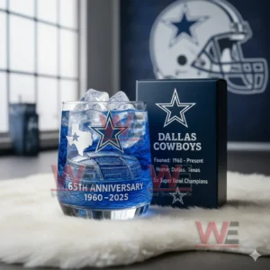Dallas Cowboys 65th Anniversary 196-2025 Whiskey Glass 6 A blue Dallas Cowboys anniversary glass with ice next to a team box in a room with Cowboys decor!