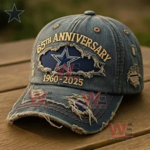 Close up of a distressed denim baseball cap with frayed edges star patch and embroidered 65th Anniversary 1960 2025 lettering on the front.