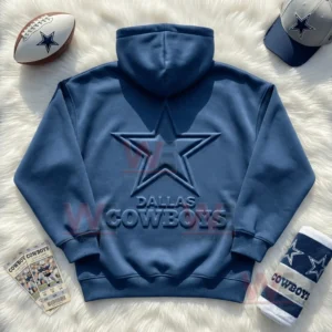 Dallas Cowboys Embossed Hoodie 3 Flat lay of a blue Dallas Cowboys hoodie with raised star logo surrounded by football items on a white background!