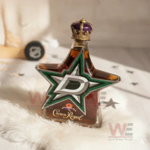 Star shaped Dallas Stars whiskey bottle with green star logo amber whiskey crown stopper and collector display setting on white fur
