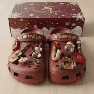 Red clogs decorated with music themed charms placed before a festive holiday box!