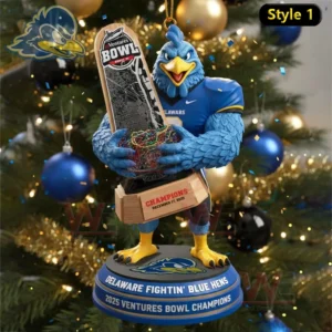 Delaware Blue Hens mascot ornament holding a Ventures Bowl trophy in front of a Christmas tree with lights and ornaments.