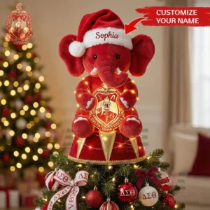 Red plush elephant in Santa hat with glowing lights and Greek letter crest used as a Christmas tree topper!
