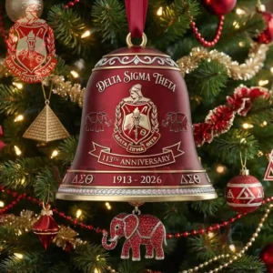 Red Delta Sigma Theta anniversary bell ornament with crest elephant designs and hanging elephant charm on a decorated Christmas tree!