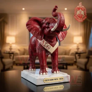 Red elephant sculpture with Greek letter sash standing on marble style base in a warmly lit room!
