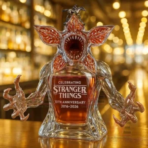 Demogorgon Stranger Things 10th Anniversary 2016-2026 Whiskey Bottle 6 A petal faced creature bottle with a small topper shown on a bar counter!