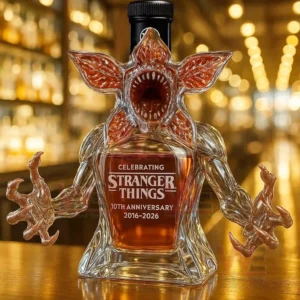 Demogorgon Stranger Things 10th Anniversary 2016-2026 Whiskey Bottle 8 A creature shaped bottle with a black cap shown on a bar counter!