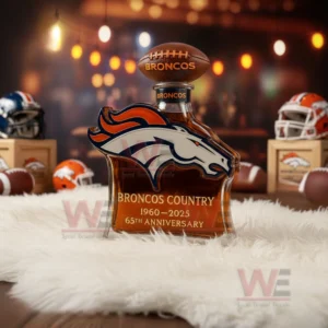 A Broncos logo bottle sits on a fluffy rug with helmets footballs and warm background lighting enhancing the scene!