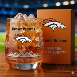 Denver Broncos themed glass with ice and amber drink placed next to an orange branded box!
