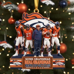 Five Denver Broncos figures including players in orange uniforms and a coach stand on a display base with a Broncos logo and a festive tree behind them!