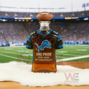 Jersey shaped Detroit Lions anniversary bottle placed on white fur with a football stadium behind it.