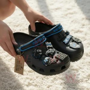 Detroit Lions Motor City Muscle Crocs Crocband Clogs with Charms 3 Hands holding black clogs decorated with Detroit Lions themed charms above a light textured surface!