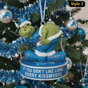 The image displays a Detroit Lions styled Grinch ornament hanging on a Christmas tree surrounded by blue and silver decorations.