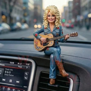 Resin figure of a blonde country musician in a decorated denim outfit and cowboy boots playing an acoustic guitar while sitting on a car dashboard with a city background!